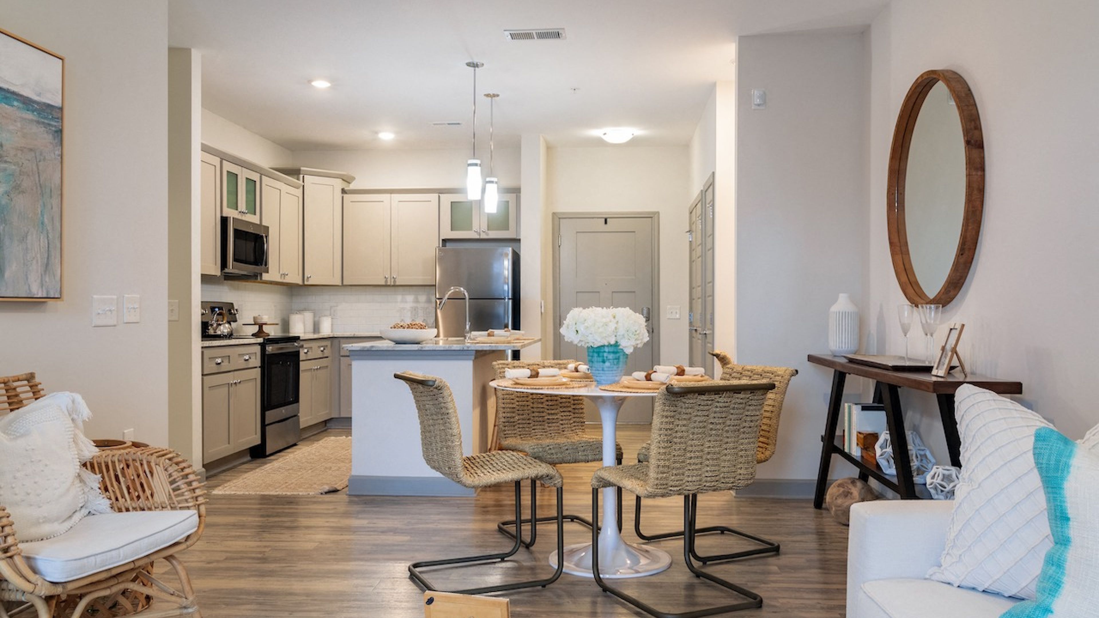 Hawthorne at Smith Creek apartment living room furnished with a dining table, coffee tables, and lounge chairs